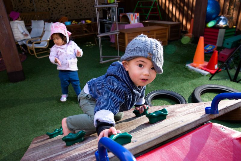 Children playing and exploring in our outdoor Montessori environment